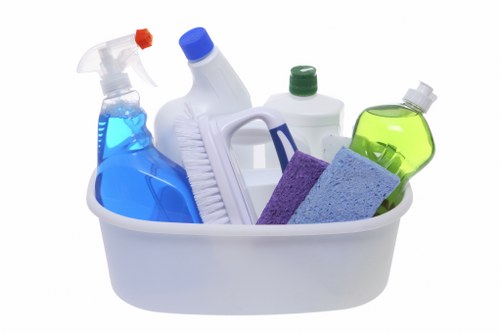 Staff member following health and safety precautions during cleaning